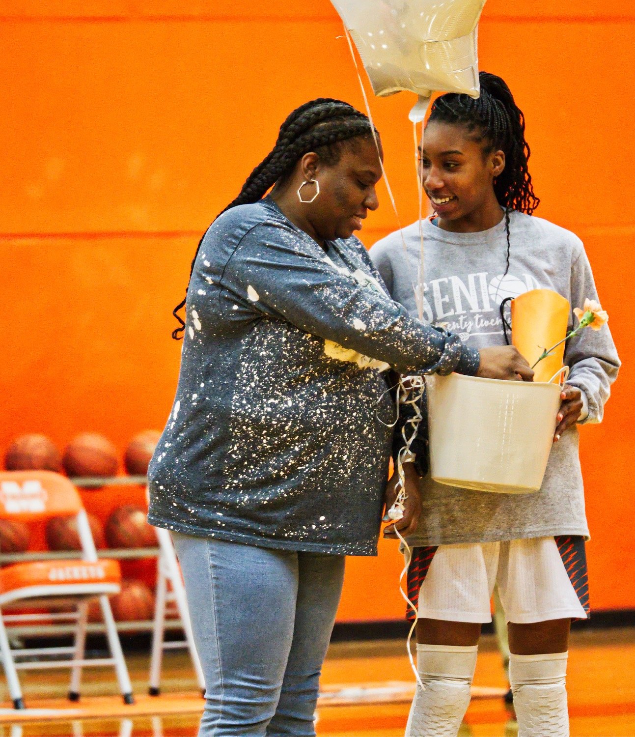 Tahjae Black and her mother share a moment during the ceremony honoring Mineola's senior girls before their final home game. [more shots, plus prints]